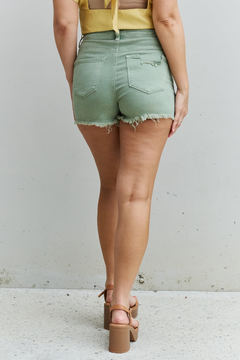RISEN Katie High Waisted Distressed Shorts in Gum Leaf