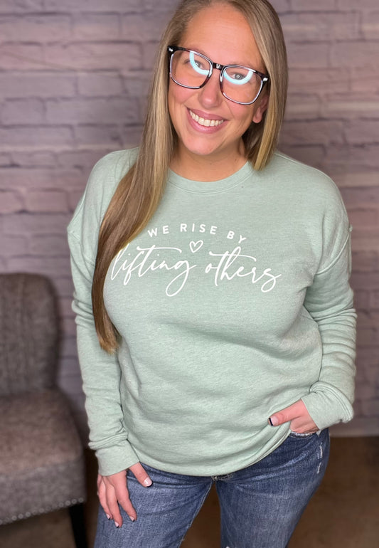 We Rise By Lifting Others Graphic Sweatshirt by Oat Collective